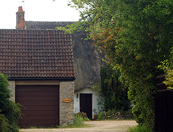 62 Village Road peers around modern housing May 2012